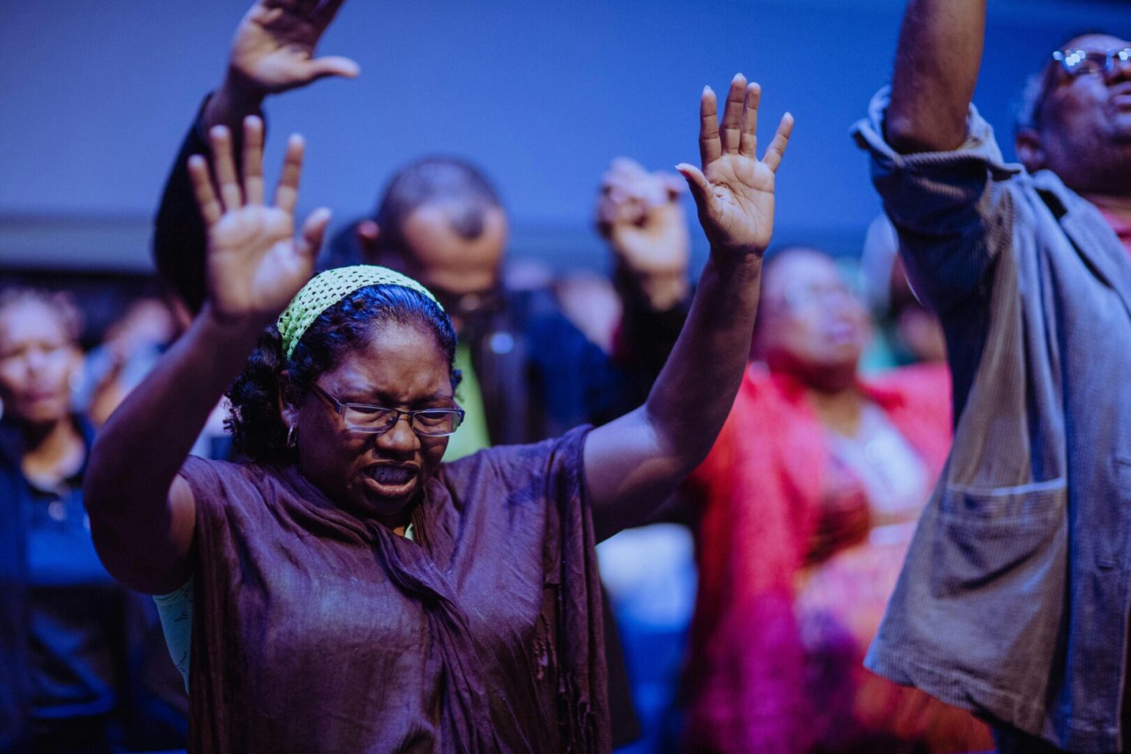 A group of people with their hands raised in the air.