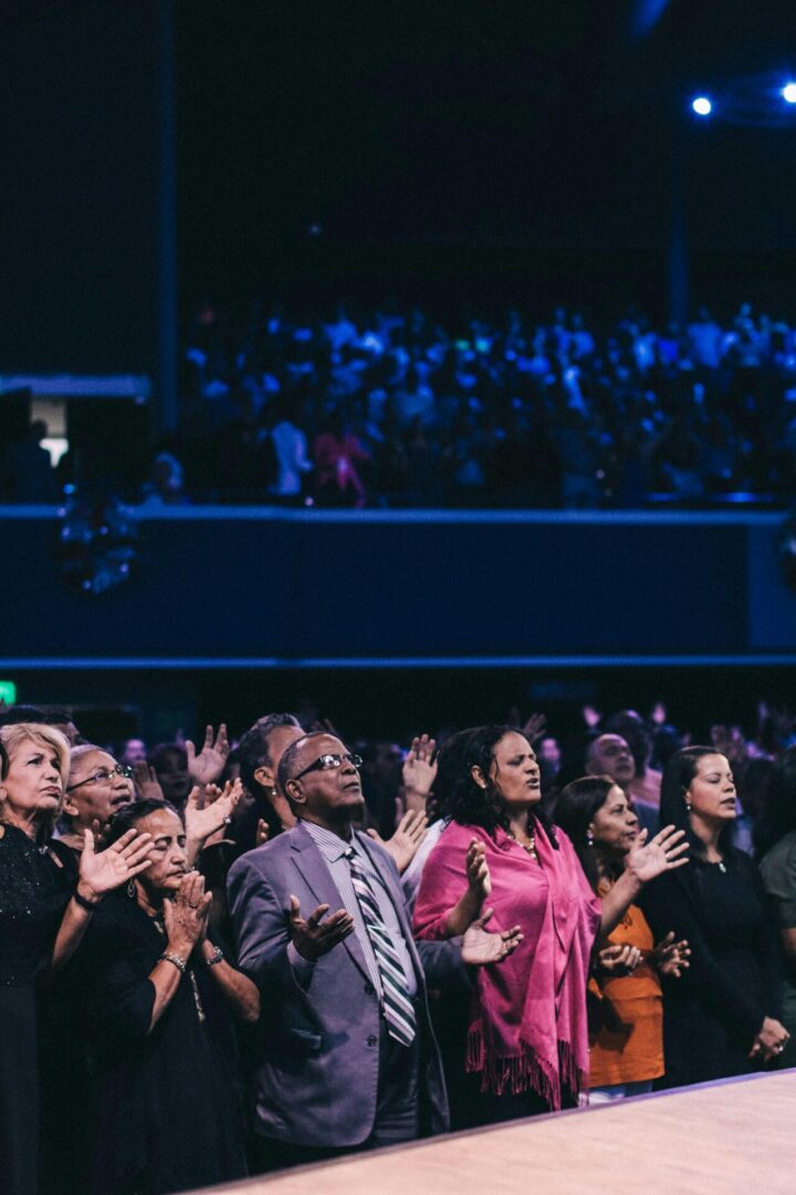 A group of people standing in front of a crowd.